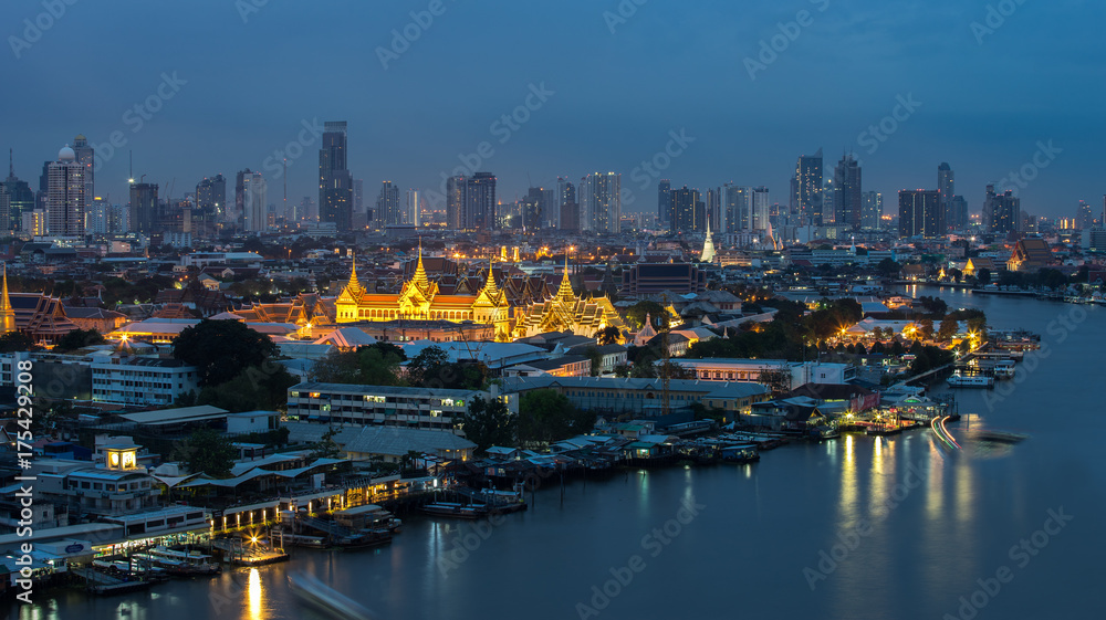 Wat Phra Kaew, Temple of the Emerald Buddha beside Chao Phraya river at twilight in Bangkok, Thailand