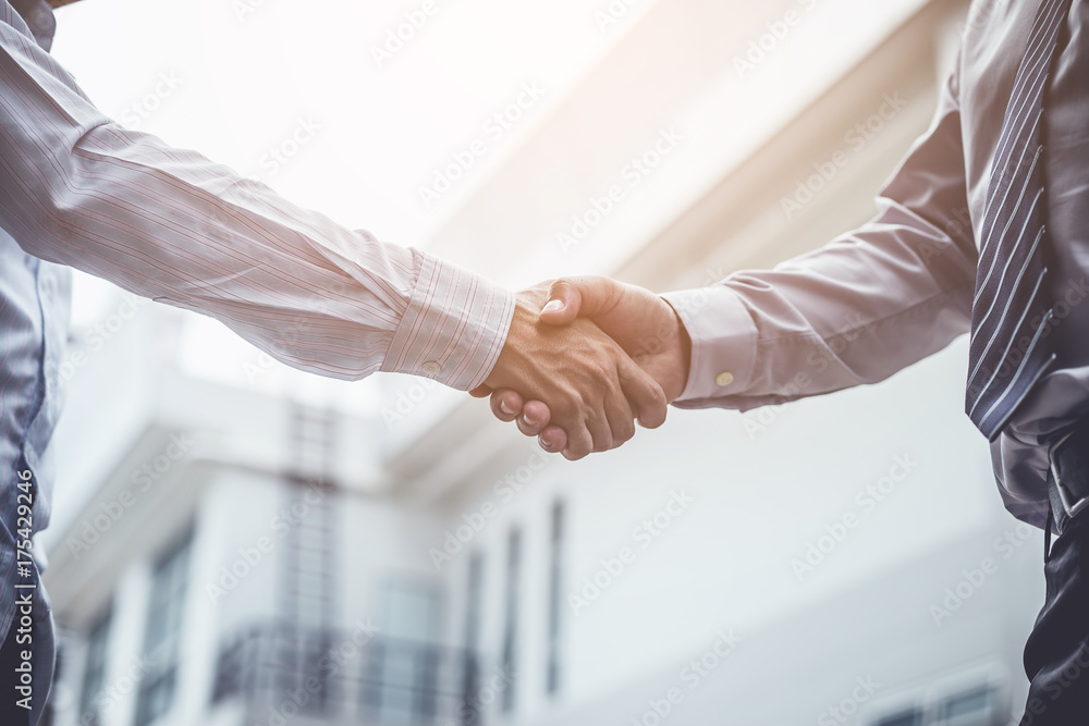 business partners handshaking after business success negotiation
