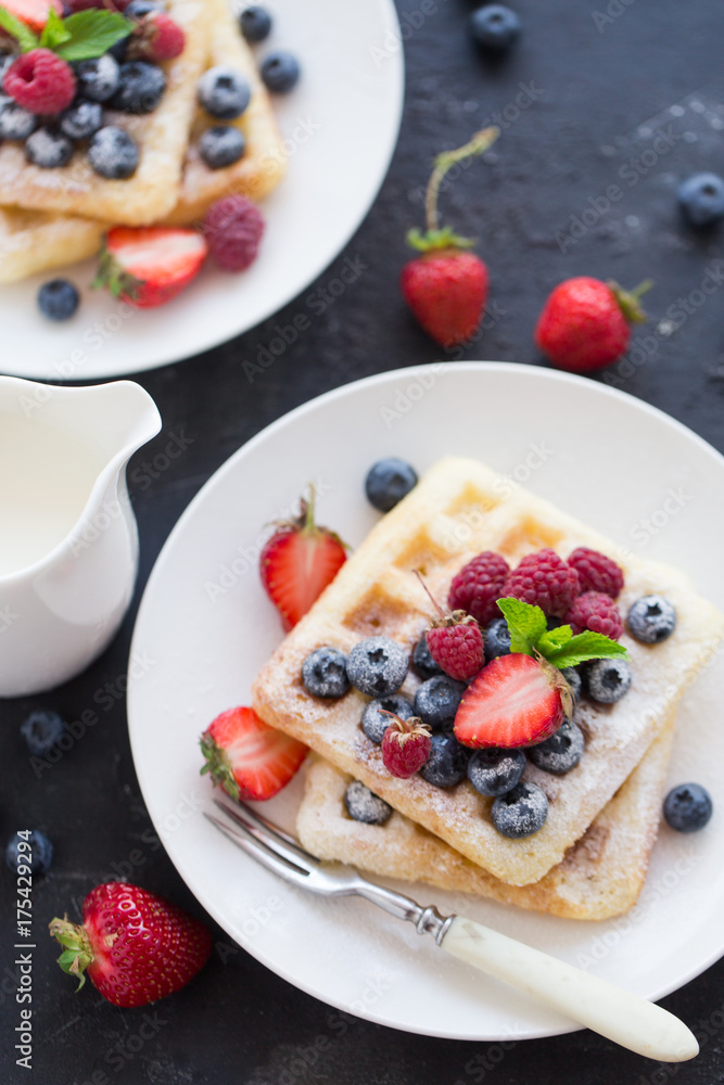 Belgian waffles with fresh berries on white plate. Belgian waffles with fresh berries on white plate.