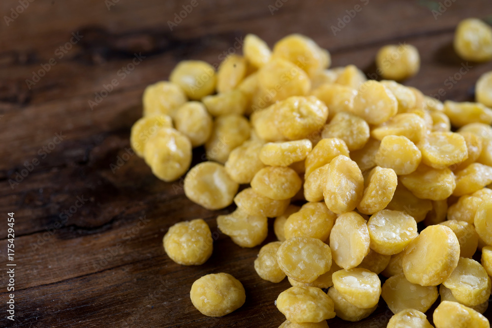 close up shot of yellow bean on wood background low key studio shotclose up shot of yellow bean on wood background studio shot close up shot of yellow bean on wood background low key studio shotclose up shot of yellow bean on wood background studio shot