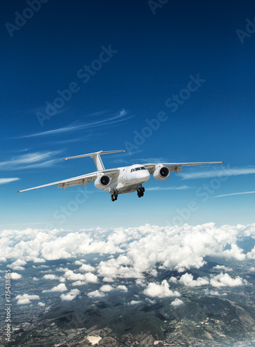 Airplane over the clouds. © volff