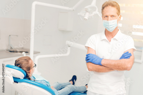 Confident dental professional posing with his arms crossed