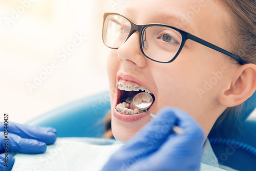 Close up of brave teen girl attending dentist photo