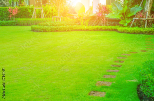 Blurred image Pathway in garden,green lawns with bricks pathways,garden landscape design