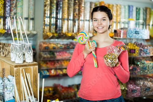  girl buying candies at shop