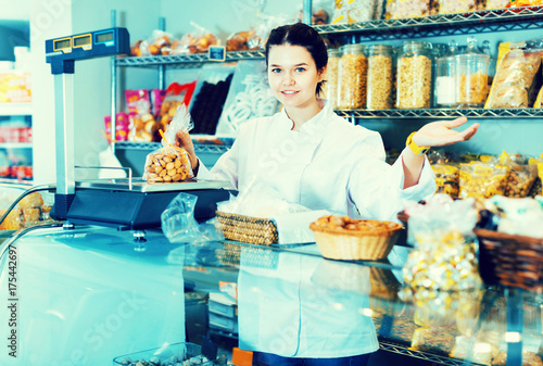 Young woman selling  cookies and other fillings photo