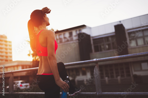 Beautiful female jogger doing her run in sunset