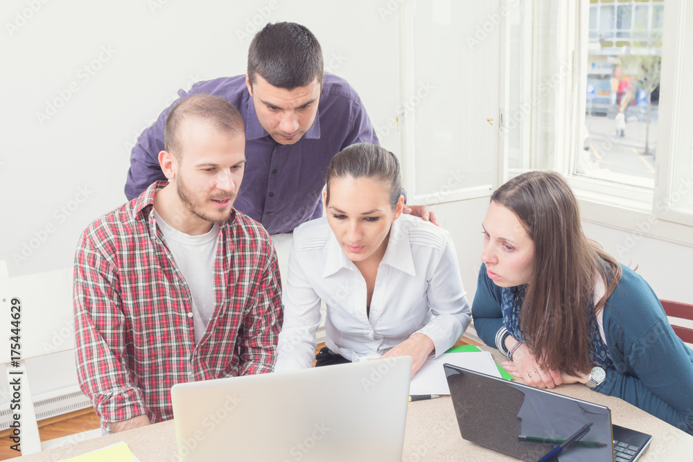 Group of young ordinary people working in the office.