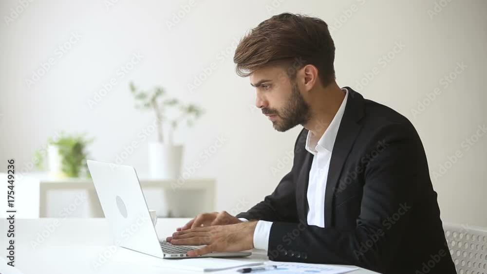 Annoyed angry businessman troubled with sudden computer failure, stressed man having problem with broken pc using laptop, pressing keys on hanging device, leaving workplace unable to fix gadget Annoyed angry businessman troubled with sudden computer failure, stressed man having problem with broken pc using laptop, pressing keys on hanging device, leaving workplace unable to fix gadget