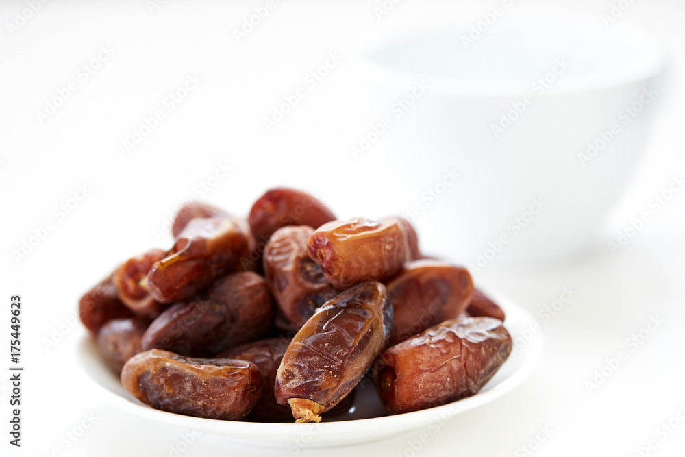 Dried Dates Fruits on dish white background Dried Dates Fruits on dish white background