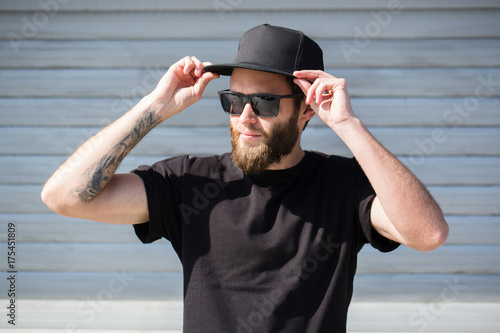 Hipster handsome male model with beard  wearing black blank  baseball cap  with space for your logo