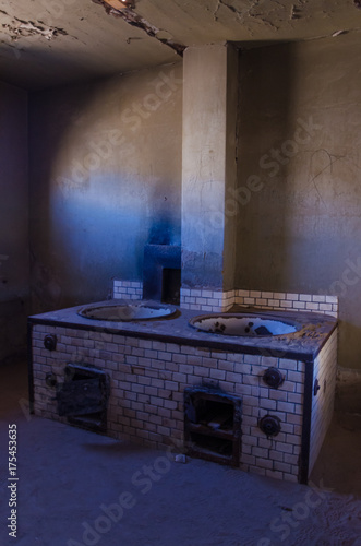 Ruins of once prosperous German mining town Kolmanskop in the Namib desert near Luderitz, Namibia, Southern Africa photo