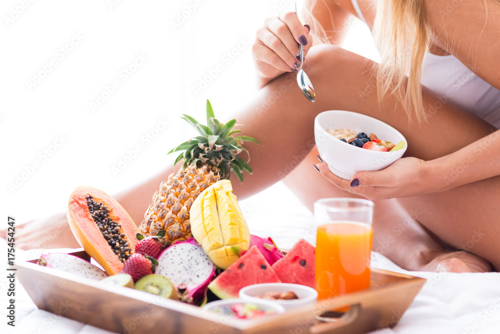 Close up of a pleasant woman enjoying her healthy meal in bed