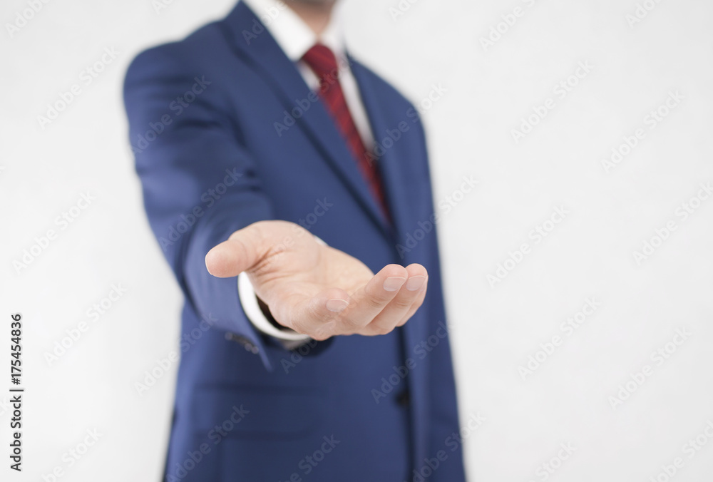 Businessman with open hand. Holding, giving, showing concept.