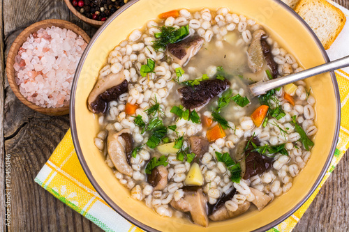 Soup with pearl barley and forest mushrooms