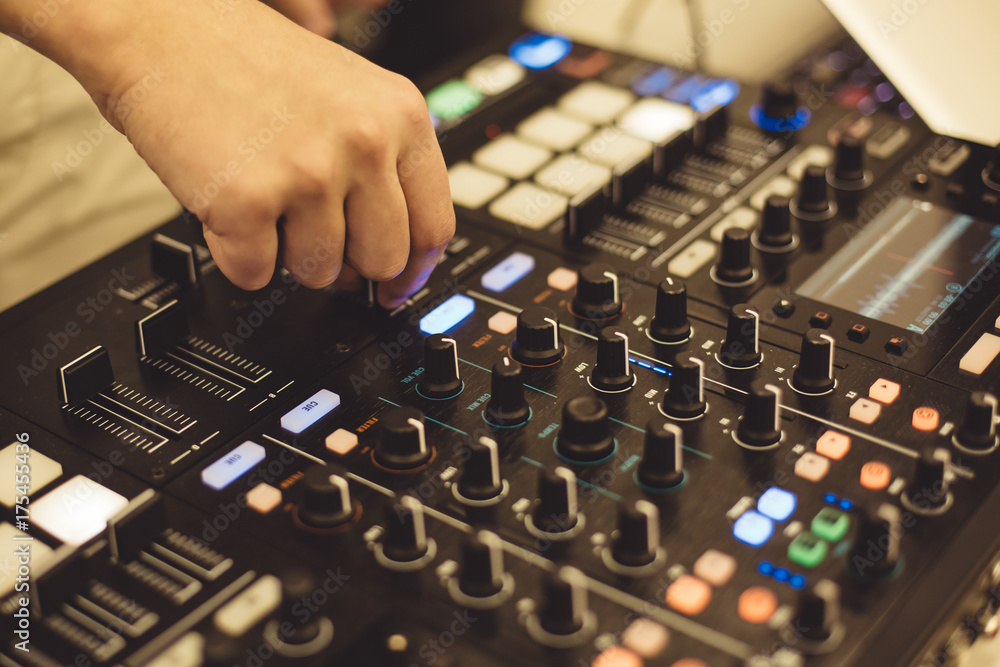 Close-up hands of soundman working with audio mixing board. Close-up hands of soundman working with audio mixing board.