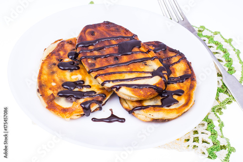Fritters with chocolate on white plate