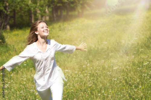 Happy Young Woman Enjoying Summer on the Green Meadow.