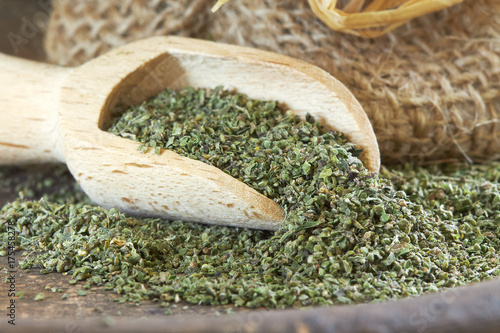 Stinging nettle (Urtica dioica) seeds in wooden scoop