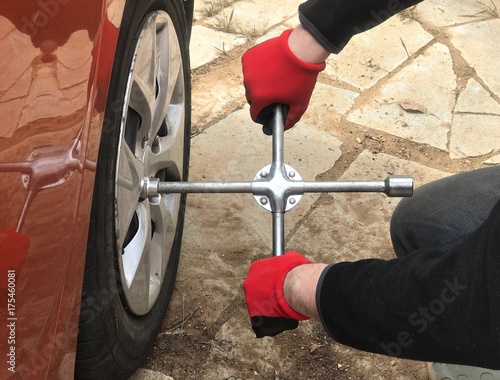 Tire fitting with cross wheel wrench. work process