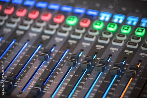 Slide the audio mixer in the control room.