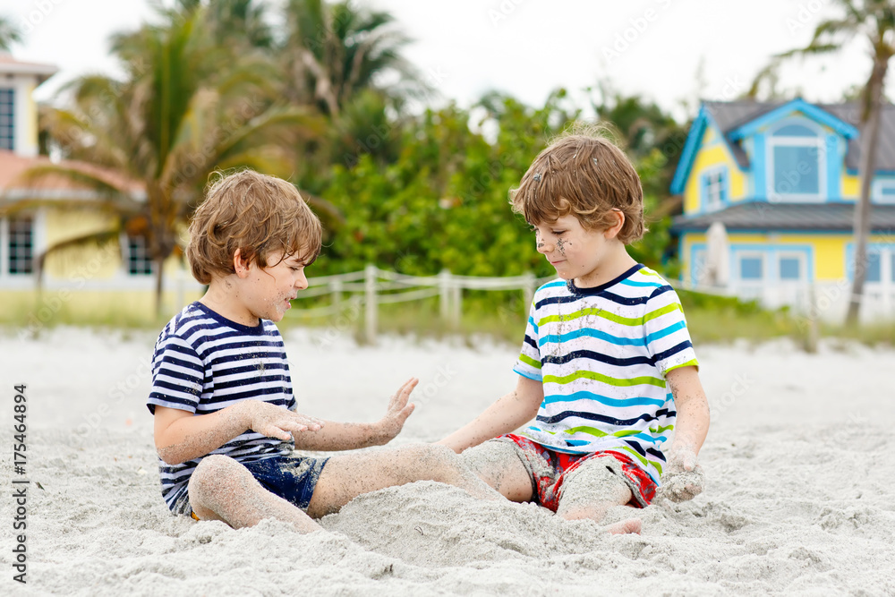 Two little kids boys having fun on tropical beach Two little kids boys having fun on tropical beach