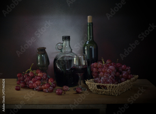 Grape and wine with lantern off on the plank in dim light room