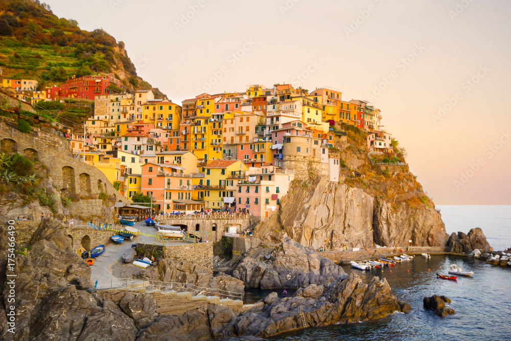 Colorful and beautiful houses, village in Manarola with sunset, Cinque terre Italy famous place.