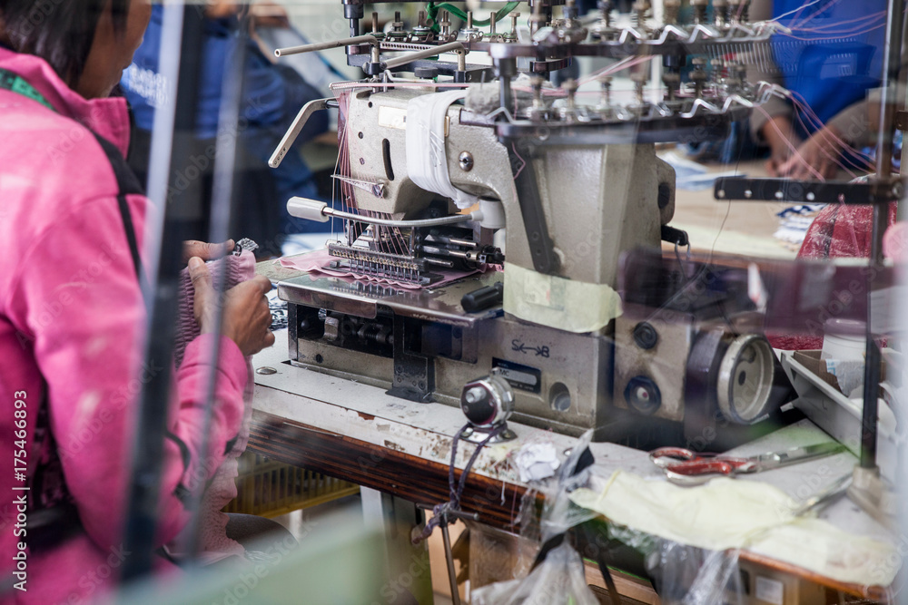 Seamstress working on industrial smocking sewing machine in factory, Cape Town, South Africa Seamstress working on industrial smocking sewing machine in factory, Cape Town, South Africa
