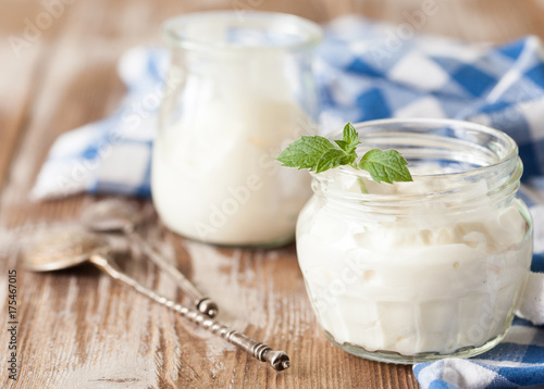 Fresh natural homemade yogurt on rustic wooden background