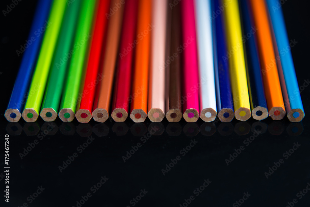 Multicolored pencils on a black background Multicolored pencils on a black background