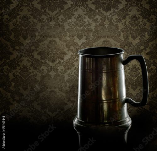Wallpaper Mural Old pewter drinking mug, tankard. With back lighting and old damask wallpaper behind. Torontodigital.ca
