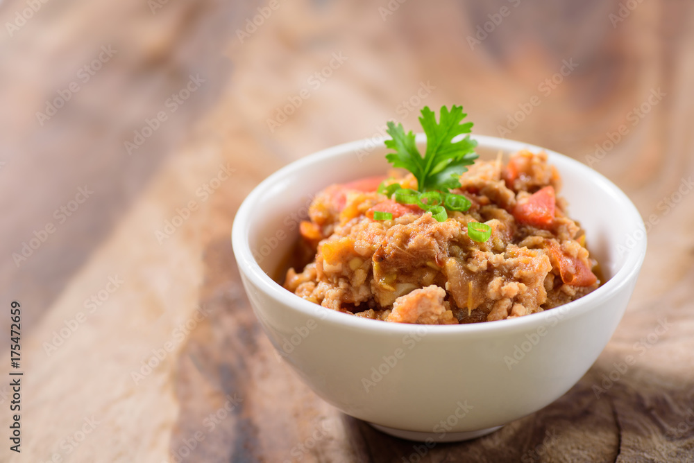 Northern Thai food (Nam Prik Ong) on wooden background,spicy tomato with pork,red chili dip,Northern Thai dipping sauce Northern Thai food (Nam Prik Ong) on wooden background,spicy tomato with pork,red chili dip,Northern Thai dipping sauce