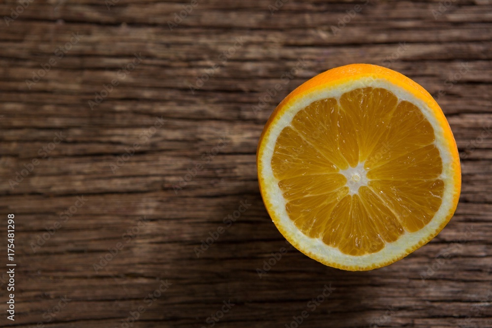 Halved orange on wooden table Halved orange on wooden table
