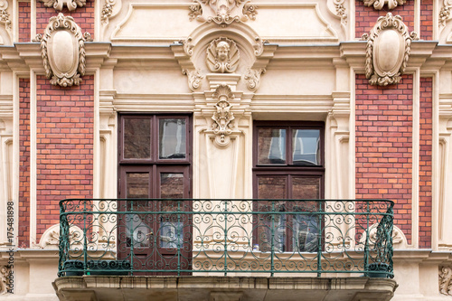 Balcony, with Windows on the facade of the vintage brick house