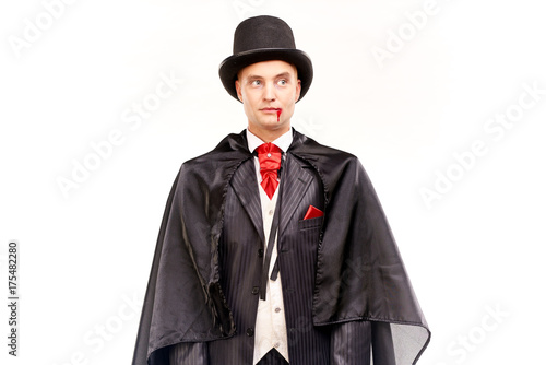 Portrait of handsome young vampire against white background