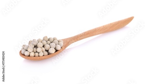 Wooden spoon and peppercorn on white background