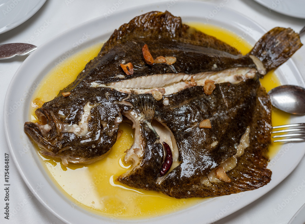 Ταπετσαρία grilled turbot fish on a white plate