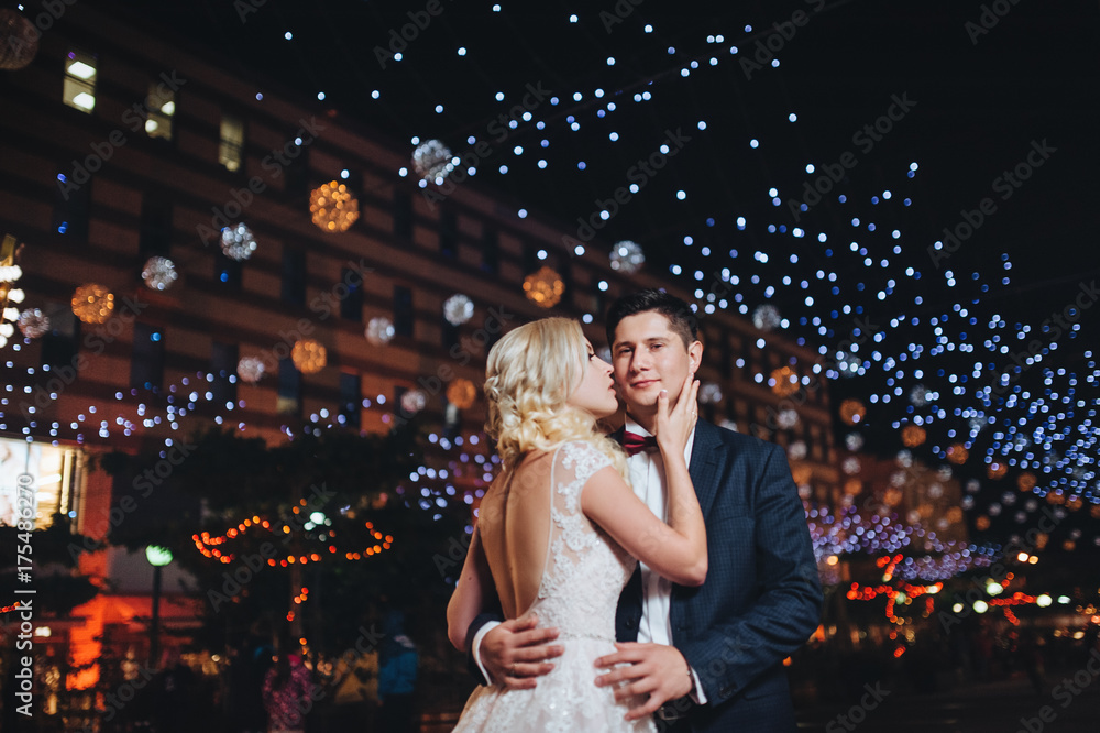 Evening photography of the newlyweds on the streets of the city that lit the lights. Evening photography of the newlyweds on the streets of the city that lit the lights.