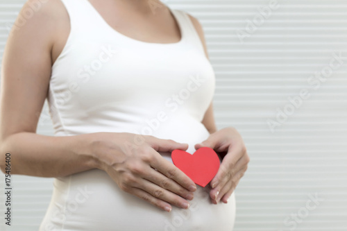 Wallpaper Mural Picture of pregnant woman holding heart sign to one side Torontodigital.ca