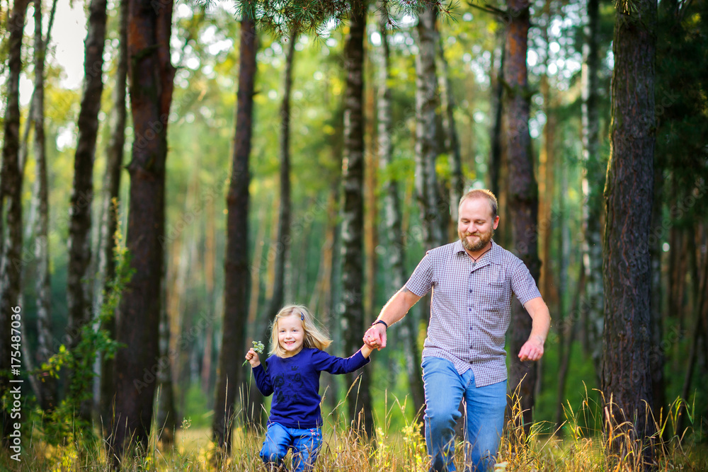 dad walks in the park with his beloved daughter, run and have fun