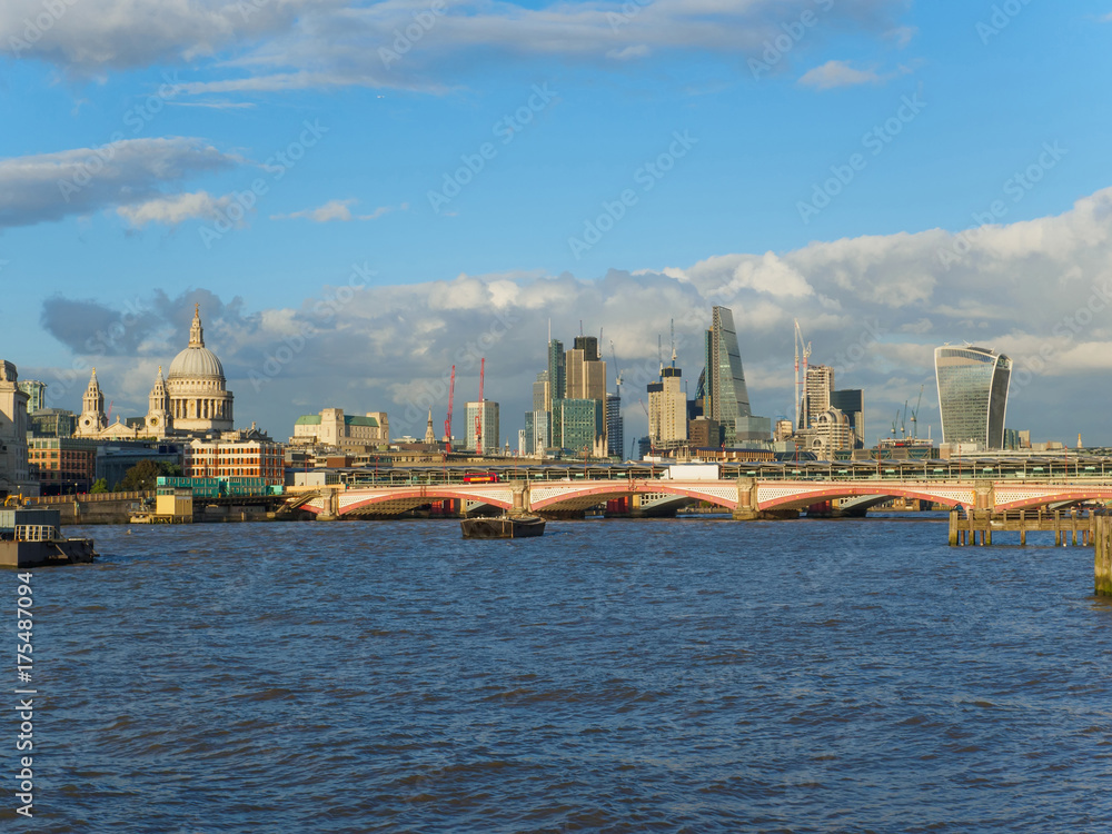 London skyline with a view of the River Thames, St Paul's Cathedral, Blackfriars Bridge and skyscrapers of the City on a sunny afternoon.