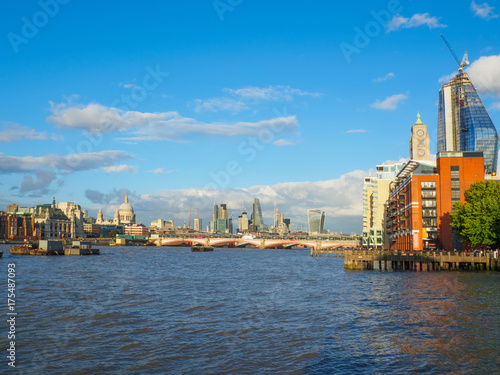 London skyline with a view of St Paul's Cathedral, Blackfriars Bridge and skyscrapers of the City on a sunny afternoon.