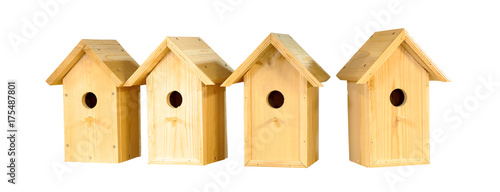 Many birdhouses isolated on white background, several wooden houses for birds. Caring for feathered friends, nesting box