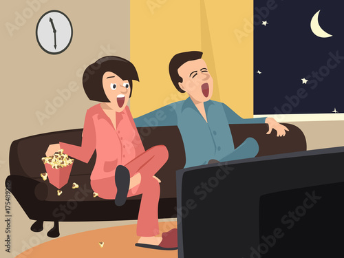 couple watching tv at home at night
