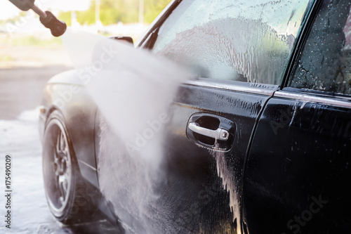 Fotografie Washing car in a car wash self service station