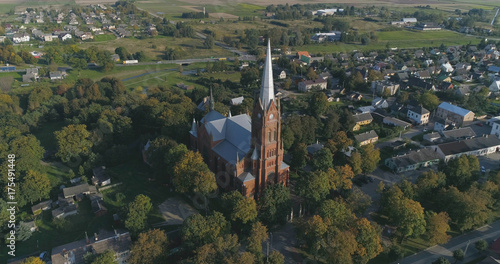 Aerial shot of St. John church of Ramygala in Lithuania..Panorama of city in early autumn.