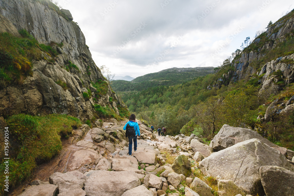 Woman is hiking in the mountains in summertime Woman is hiking in the mountains in summertime