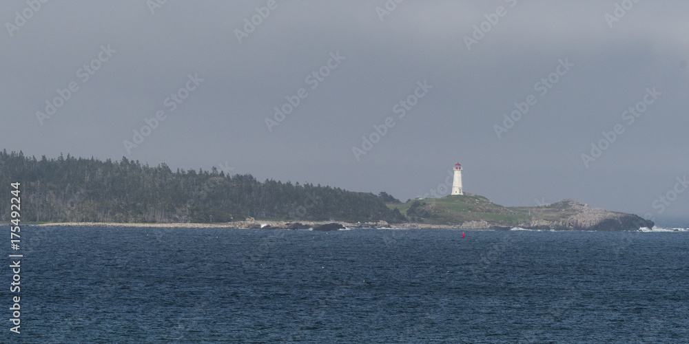 Scenic view of lighthouse at coast, Louisbourg Harbour, Louisbourg, Cape Breton Island, Nova Scotia, Canada