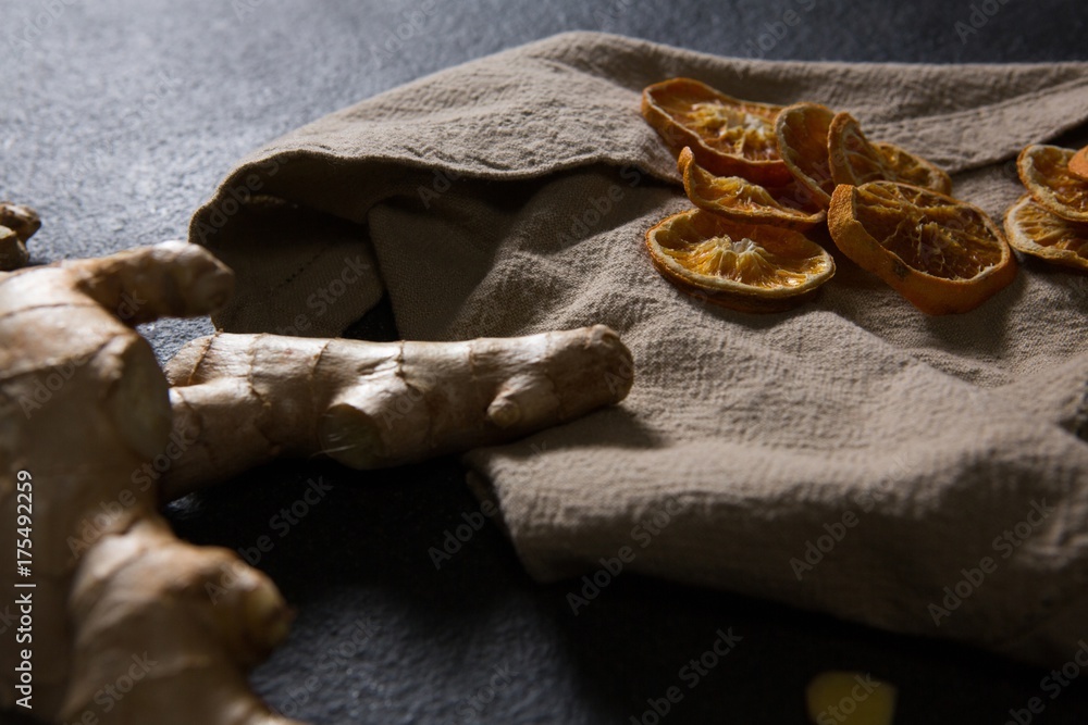 Ginger and dried orange sliced on textile Ginger and dried orange sliced on textile